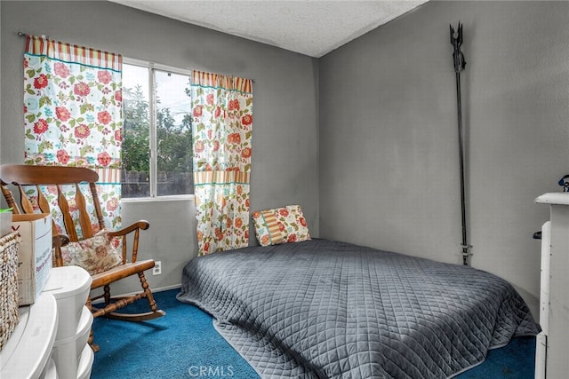 carpeted bedroom featuring a textured ceiling