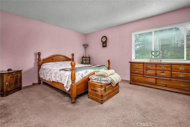 carpeted bedroom featuring a textured ceiling