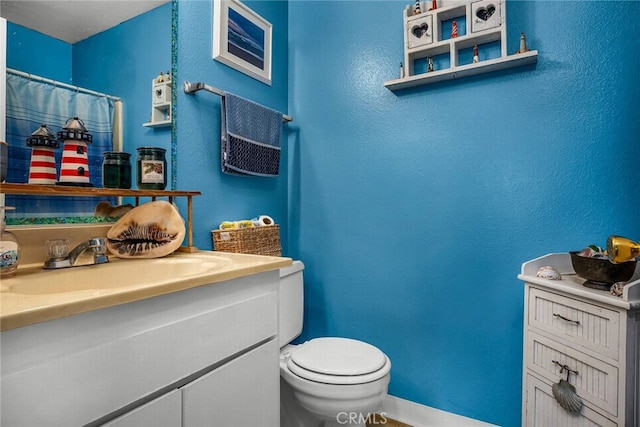 bathroom with vanity and toilet