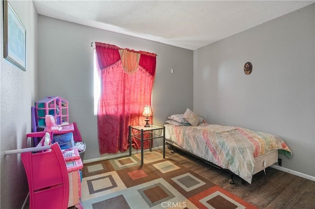 bedroom featuring dark hardwood / wood-style flooring