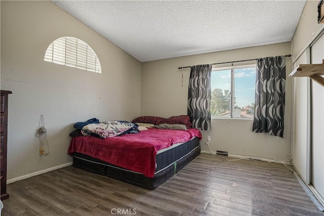 bedroom featuring hardwood / wood-style floors and a textured ceiling