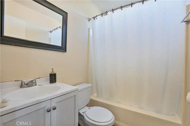 full bathroom featuring vanity, shower / bath combo, and toilet