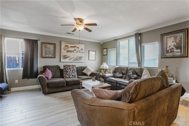 living room with a textured ceiling, light hardwood / wood-style floors, ceiling fan, and crown molding