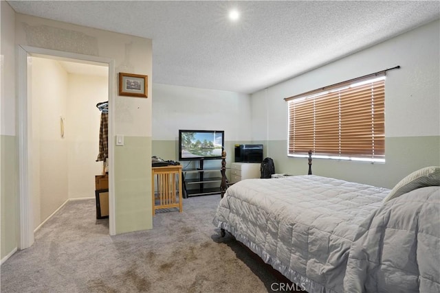 carpeted bedroom with a textured ceiling