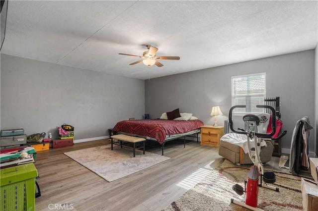 bedroom with ceiling fan and light hardwood / wood-style flooring