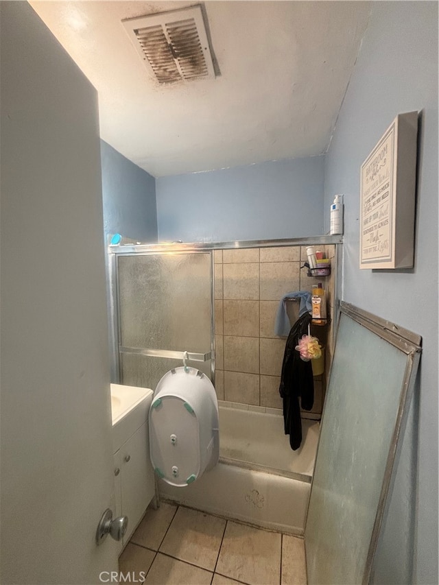 full bathroom featuring vanity, enclosed tub / shower combo, toilet, and tile patterned flooring