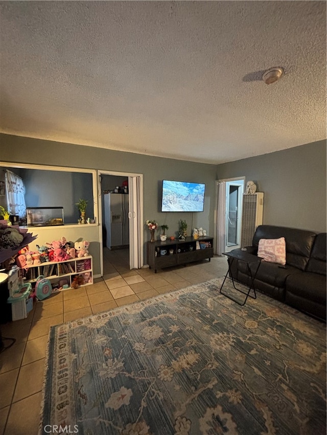 living room with a textured ceiling and tile patterned flooring