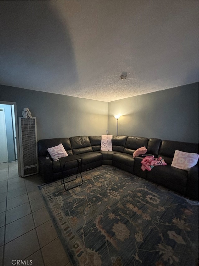 tiled living room with a textured ceiling