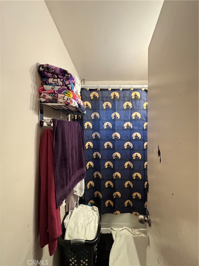 bathroom featuring lofted ceiling