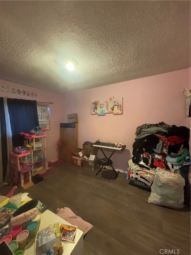 bedroom featuring a textured ceiling and wood-type flooring