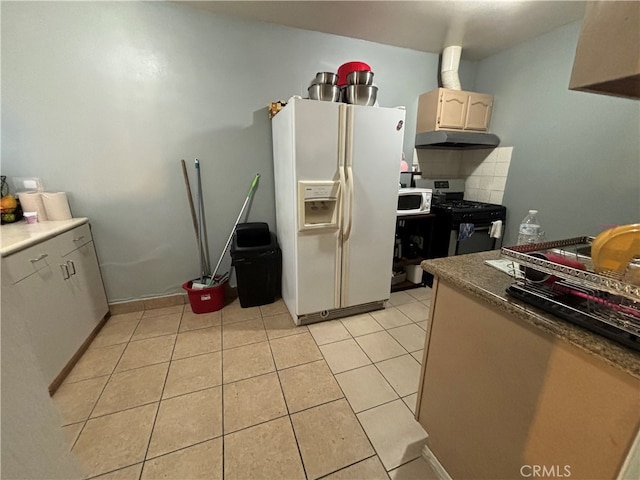 kitchen with white fridge with ice dispenser, tasteful backsplash, black range with gas cooktop, and light tile patterned floors