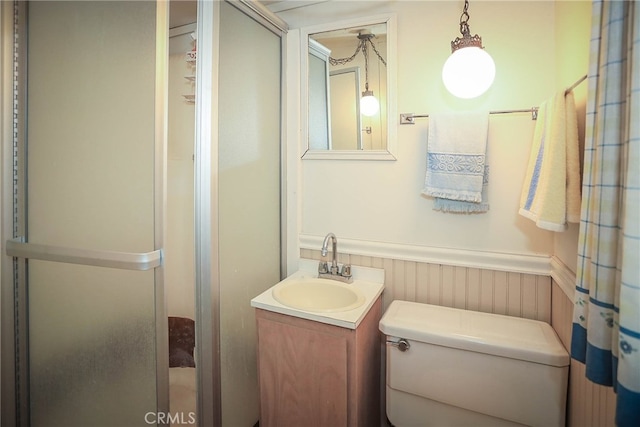 bathroom featuring vanity, toilet, and curtained shower