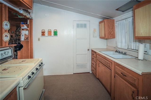 kitchen featuring sink, white stove, vaulted ceiling, and carpet floors