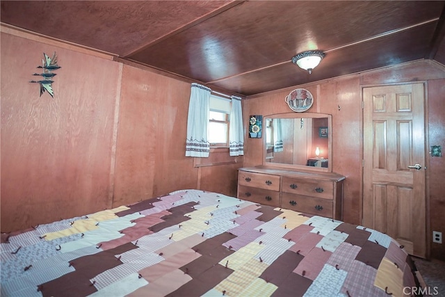 bedroom featuring wood ceiling, wood walls, and vaulted ceiling