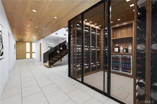 wine area featuring tile patterned flooring and wooden ceiling