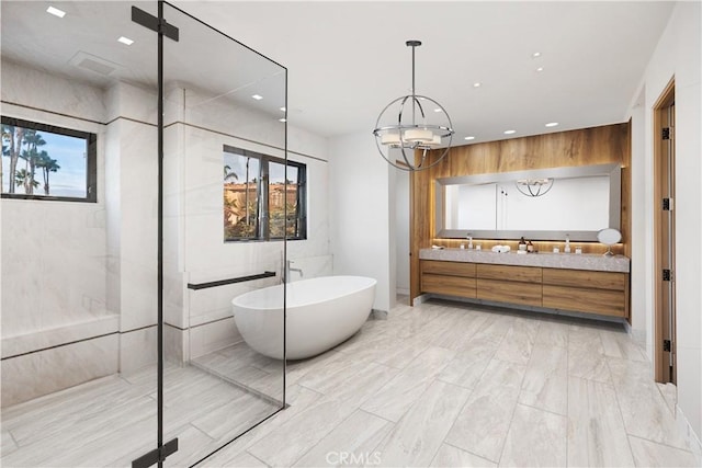 bathroom featuring vanity, shower with separate bathtub, and an inviting chandelier