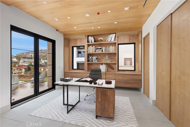 tiled office featuring built in shelves and wooden ceiling