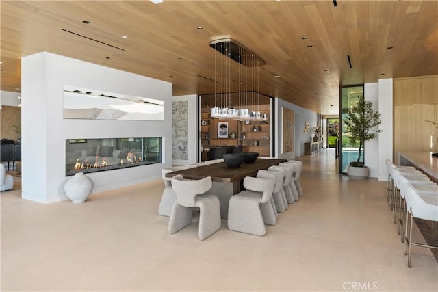 13 Ritz Cove Dr, Dana Point, CA 92629 - dining space featuring wooden ceiling, tile patterned floors, vaulted ceiling, and a glass covered fireplace