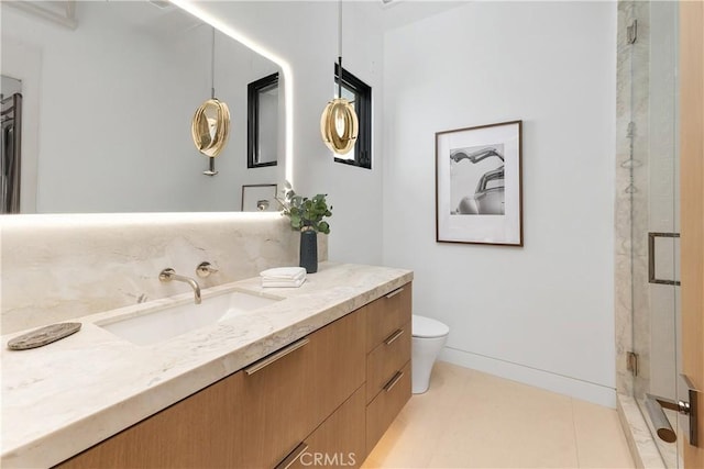 13 Ritz Cove Dr, Dana Point, CA 92629 - bathroom with vanity, toilet, a stall shower, and baseboards