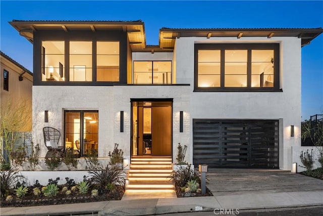 13 Ritz Cove Dr, Dana Point, CA 92629 - view of front of house with stucco siding, an attached garage, and driveway