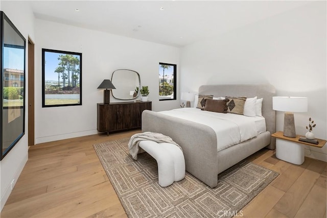 13 Ritz Cove Dr, Dana Point, CA 92629 - bedroom featuring light wood-style flooring, multiple windows, and baseboards