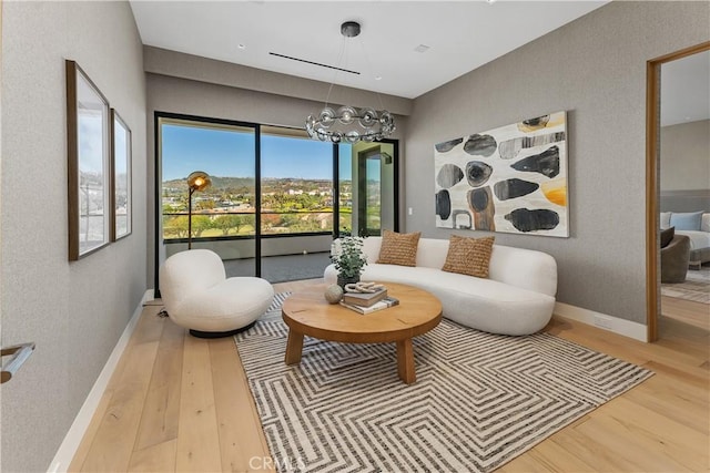 13 Ritz Cove Dr, Dana Point, CA 92629 - sitting room with wood finished floors, a chandelier, and baseboards