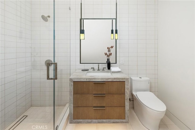 13 Ritz Cove Dr, Dana Point, CA 92629 - bathroom with tile walls, a stall shower, toilet, vanity, and tile patterned floors