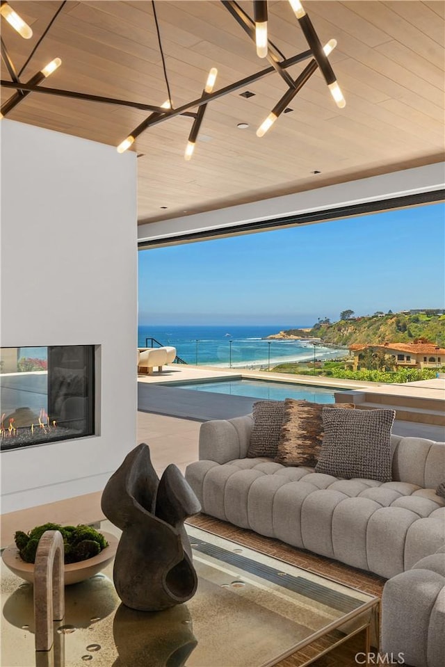 13 Ritz Cove Dr, Dana Point, CA 92629 - living area with wooden ceiling, a water view, and a chandelier