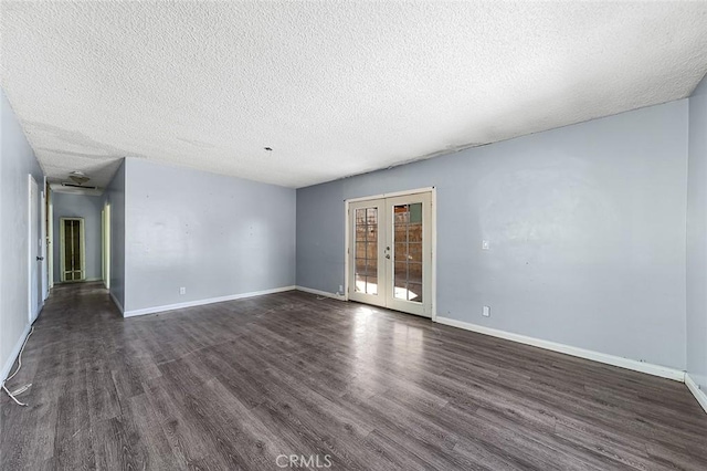 empty room with french doors, dark hardwood / wood-style flooring, and a textured ceiling