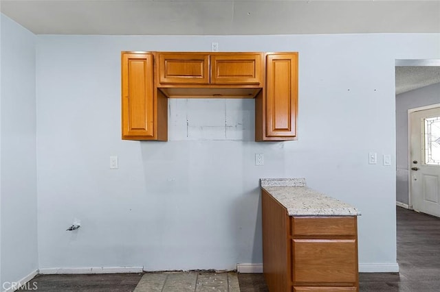 kitchen featuring light stone countertops and hardwood / wood-style flooring