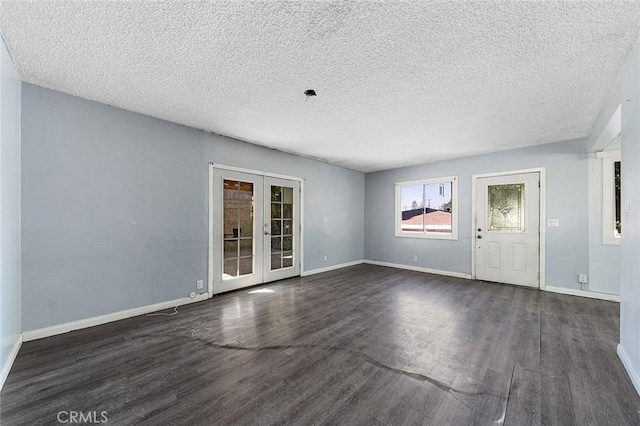 interior space with french doors, a textured ceiling, and dark hardwood / wood-style floors