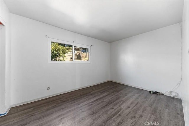 unfurnished room featuring dark hardwood / wood-style flooring