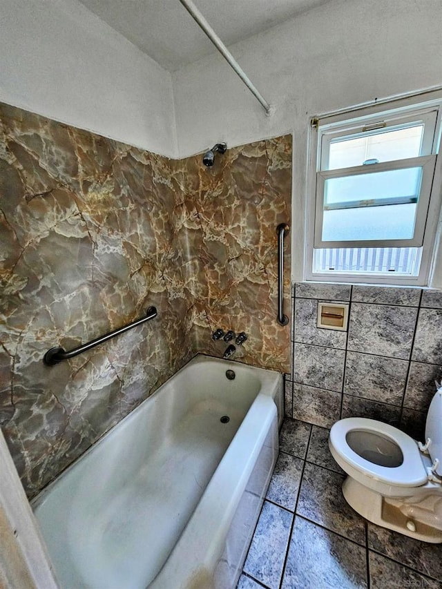 bathroom with a textured ceiling, toilet, tile walls, and tub / shower combination