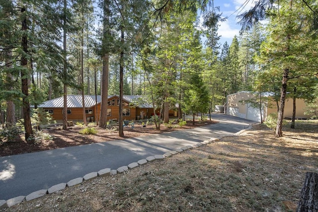 view of front of property with an outdoor structure and a garage