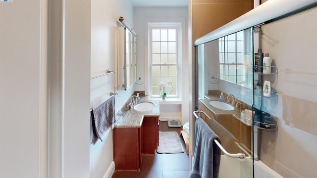 bathroom with vanity, tile patterned floors, and a shower with door