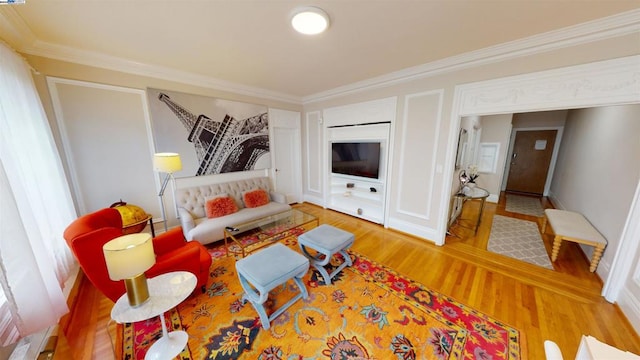 living room with hardwood / wood-style floors and ornamental molding