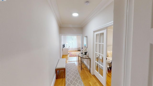 hallway with crown molding and light wood-type flooring