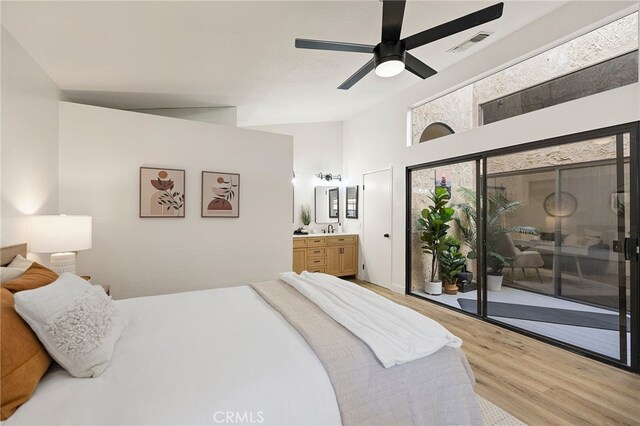 bedroom featuring wood-type flooring, lofted ceiling, ceiling fan, and access to exterior