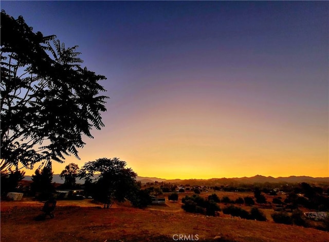 nature at dusk featuring a rural view