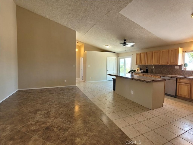 kitchen with a breakfast bar, a textured ceiling, stainless steel dishwasher, and a healthy amount of sunlight