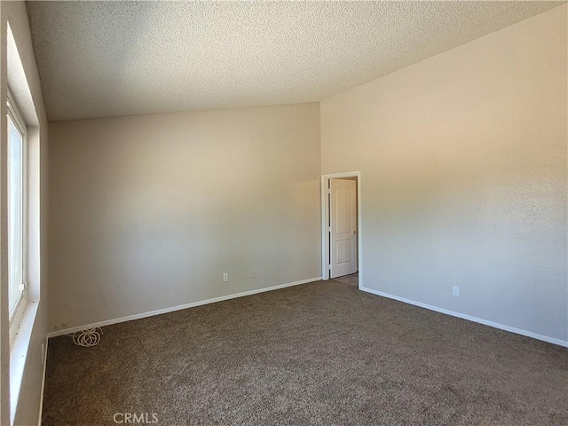 carpeted spare room with a textured ceiling