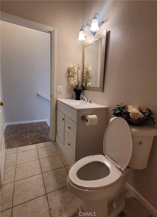 bathroom featuring toilet, vanity, and tile patterned floors