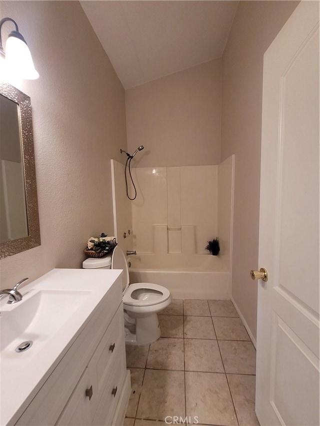 full bathroom featuring tile patterned flooring, vaulted ceiling, tub / shower combination, and toilet