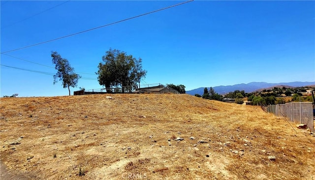 view of yard with a mountain view and a rural view