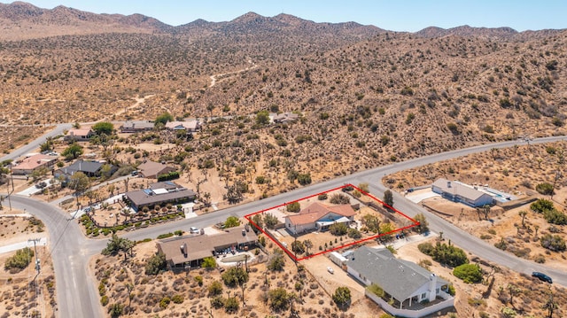 birds eye view of property featuring a mountain view