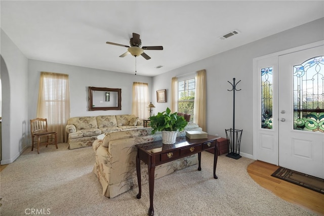 living room with ceiling fan and light wood-type flooring