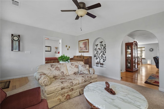 living room with light hardwood / wood-style floors and ceiling fan