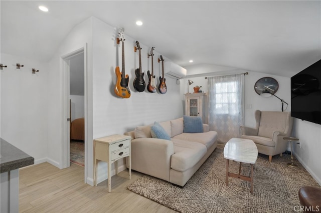 living room featuring light wood-type flooring, vaulted ceiling, and a wall mounted air conditioner