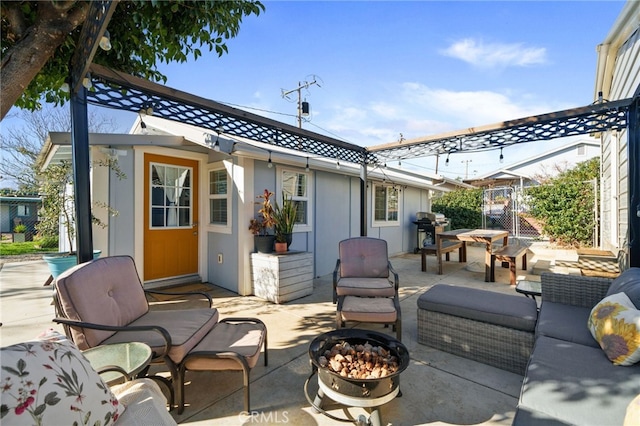 view of patio featuring grilling area and an outdoor living space with a fire pit