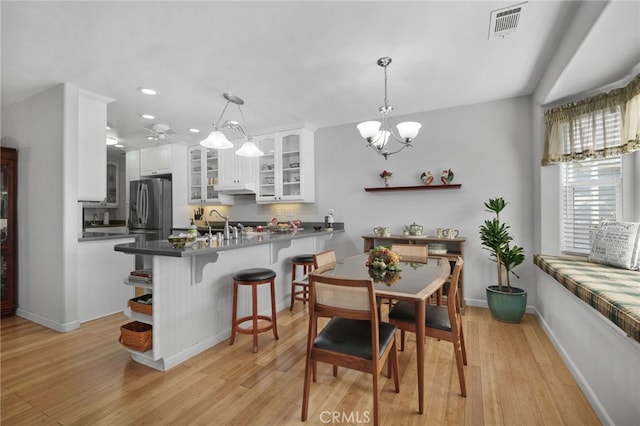 dining room featuring a chandelier and light hardwood / wood-style floors